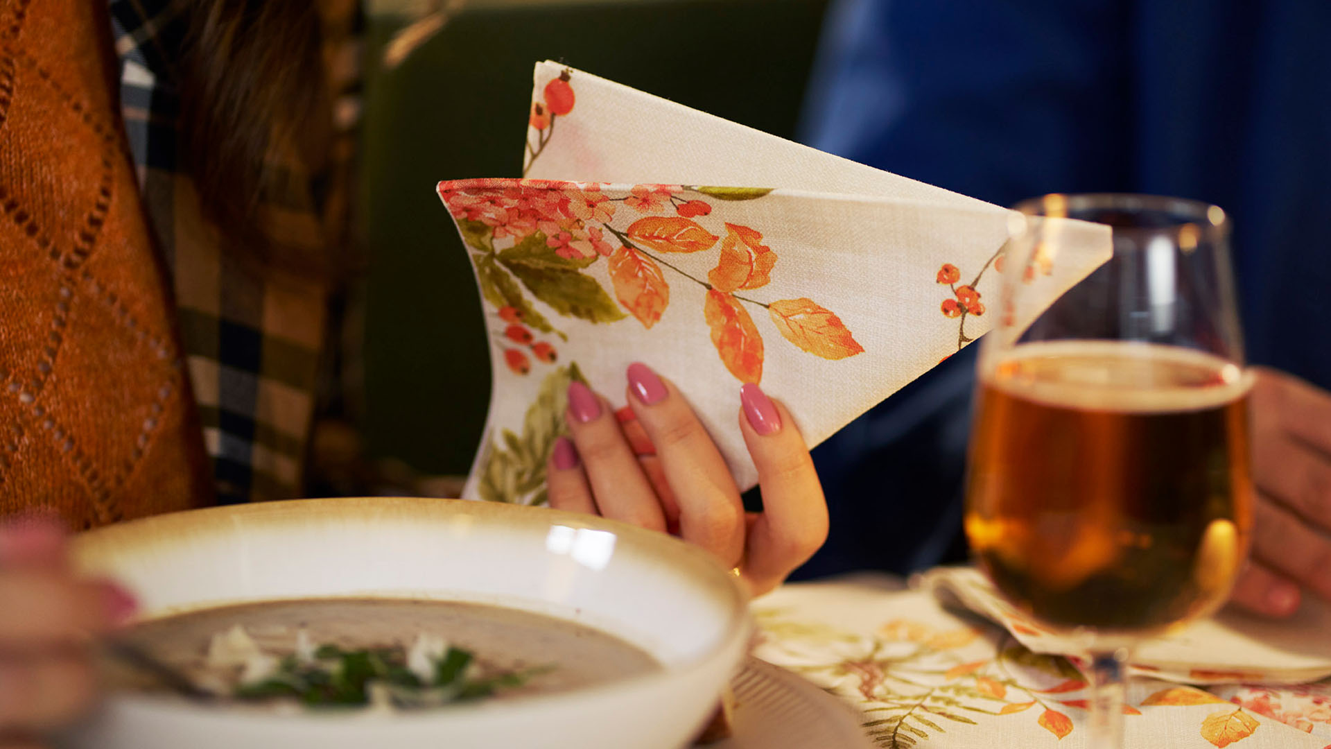 Duni new autumn design spicy pumpkin held in a woman's hand at a restaurant dinner table Duni new autumn design spicy pumpkin held in a woman's hand at a restaurant dinner table