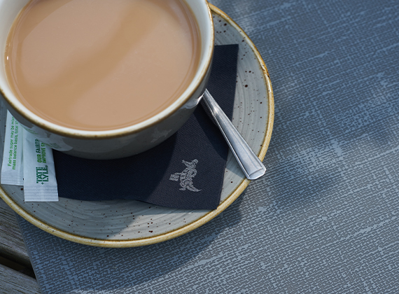 Close-up of a coffee cup on Dunisilk® weatherproof table cover