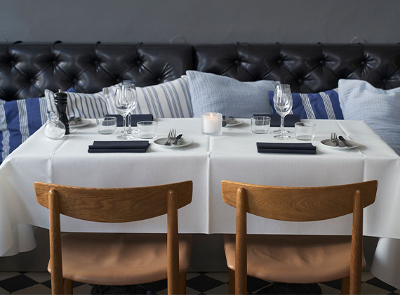 White linen-like tablecloth with navy blue large napkins on table