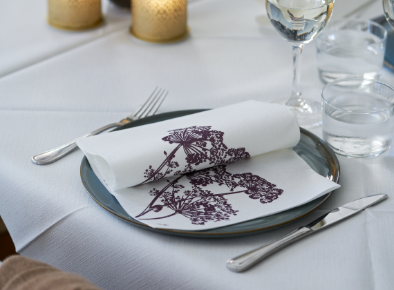 A  folded napkin with floral design on a plate